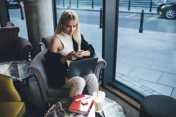 Serious Female Freelancer Stylish Clothes Sitting Netbook Knees Watching Video — Stock Photo, Image