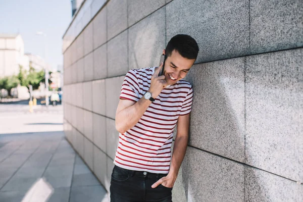 Young Man Laughing While Having Conversation Smartphone Holding Hand Pocket — Stock Photo, Image