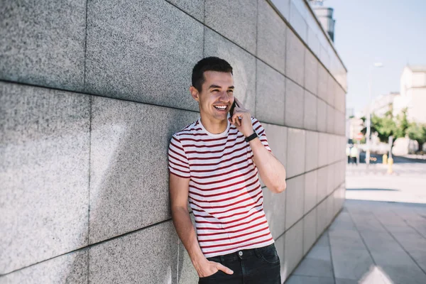 Positive Young Man Wearing Casual Clothes Answering Phone Call While — Stock Photo, Image