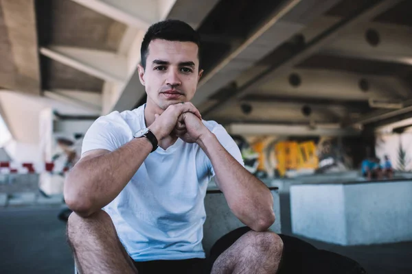 Pensive Youthful Male Wearing Shirt Shorts Wristwatch Sitting Ground Bridge — Stock Photo, Image