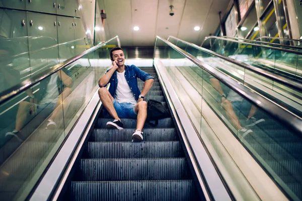 Cheerful Young Male Casual Outfit Sitting Alone Steps Escalator Modern — Stock Photo, Image