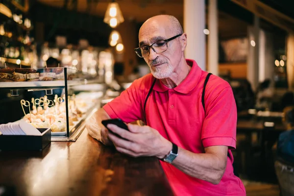 Gözlüklü Günlük Giysileri Olan Yaşlı Sakallı Adam Telefon Ekranına Dikkatlice — Stok fotoğraf