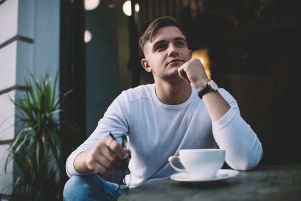 Pensive Handsome Casually Dressed Guy Touching Chin Fist While Sitting — Stock Photo, Image