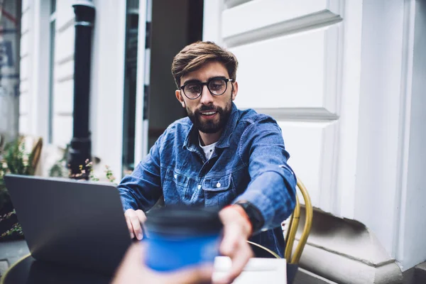 Smiling Male Remote Worker Denim Jacket Glasses Receiving Disposable Cup — Stock Photo, Image