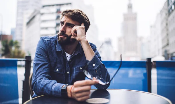 Thoughtful Bearded Male Casual Clothes Eyeglasses Hand Looking Away While — Stock Photo, Image