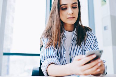 Genç Kafkasyalı blogcu akıllı telefon uyarısını uygulama yüklemek için kontrol ediyor, yeni nesil Z mobil aygıtla internete bağlanıyor online rezervasyon ve bankacılık için