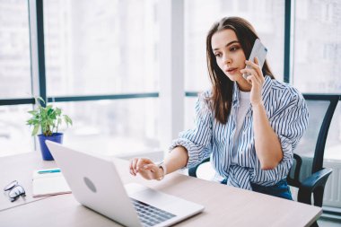 Modern çalışma alanındaki dizüstü bilgisayar programları sırasında akıllı telefon uygulaması kullanan, 4G 'ye bağlanan, cep telefonuyla konuşan,