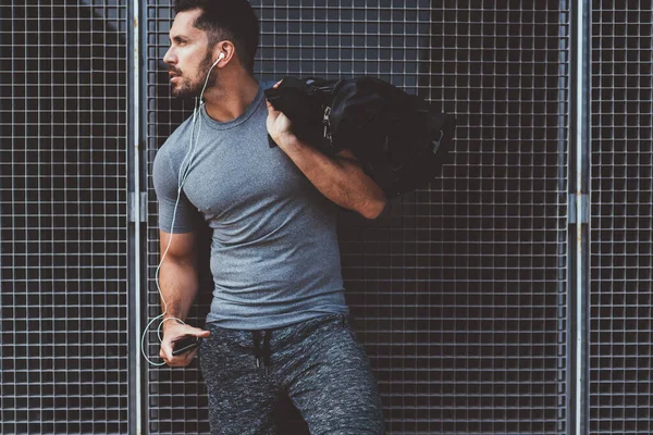 Aucasian Bodybuilder Tracksuit Holding Smartphone Gadget Sportive Bag Looking Away — Stock Photo, Image