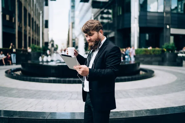Young Pensive Businessman Bushy Beard Suit Office Using Tablet Listening — 图库照片