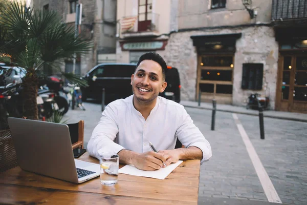 High Angle Positive Ethnic Male Freelancer Smiling Looking Away While — 图库照片