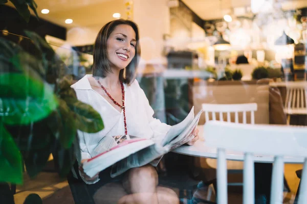 Smiling Mature Woman Trendy Clothes Red Beads Sitting Chair Window — Foto de Stock