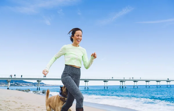 Happy Adult Female Activewear Running Seaside Dog Sunny Day Fitness —  Fotos de Stock