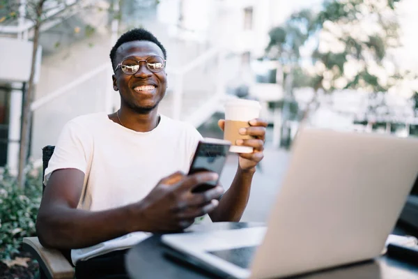 Smiling African American Hipster Guy Eyewear Enjoying Remote Job Coffee — Stock fotografie