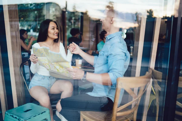 Glass Happy Diverse Couple Sitting Wooden Table Modern Cafe Map — Stock Photo, Image