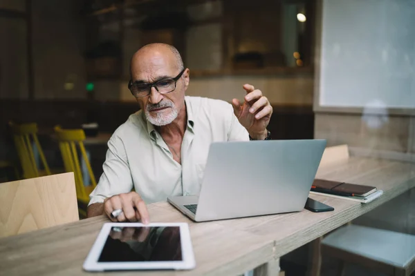 Aged Freelancer Optical Glasses Browsing Received Information Digital Tablet Sitting — Stock fotografie