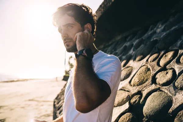 Serious Bearded Male Standing Sandy Beach Sea Listening Music Headphones — Stock Photo, Image