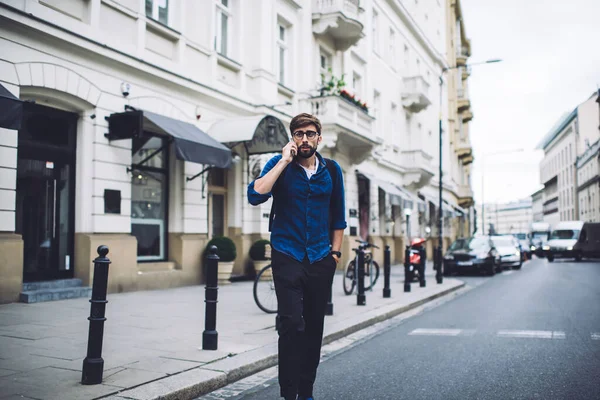 Earnest Bearded Male Wearing Denim Shirt Eyeglasses Backpack Walking Road — Stock Photo, Image