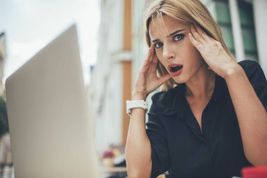 Dizüstü bilgisayar teknolojisindeki son teslim tarihi sırasında internetteki sorunla şoke olan serbest çalışan kadın portresi, yazılım güncellemesiyle ilgili sorunları çözerken mutsuz bir kadın başı hissediyordu.