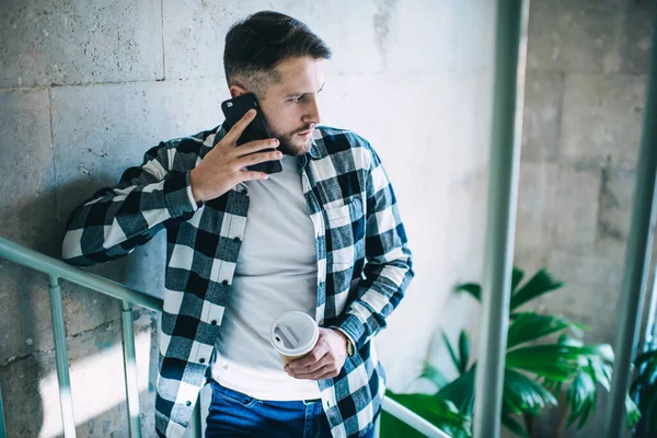 Serious Young 20S Hipster Guy Talking Mobile Phone Holding Coffee — Stock Photo, Image