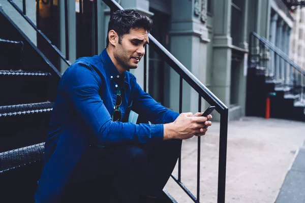 Casual Handsome Modern Man Denim Shirt Sitting Metal Steps Messaging — Stock Photo, Image