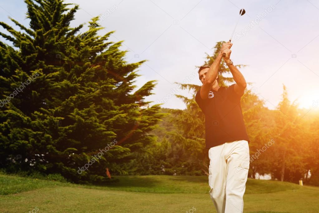 Strong golf shot of player standing on golf course