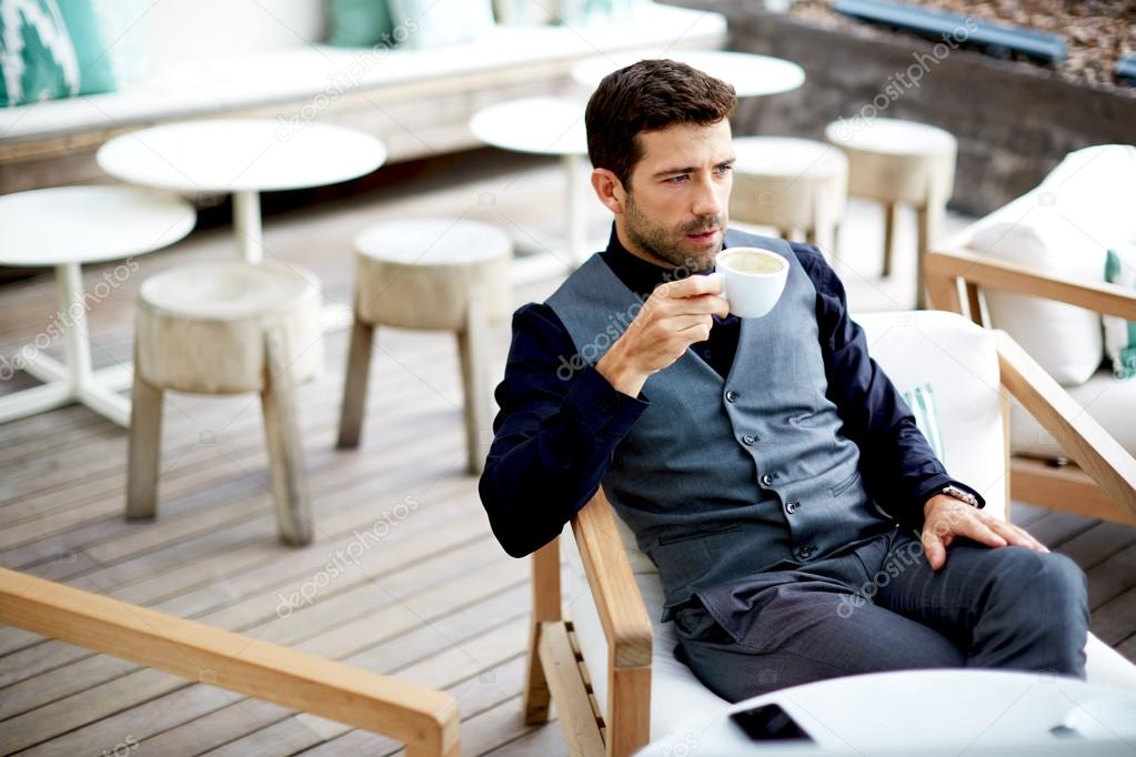 Man drinking coffee in cafe