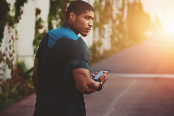 Attractive dark skinned runner walking on the road resting after fitness training outdoors — Stock Photo, Image