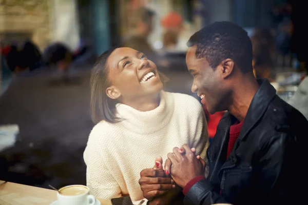 Two people in cafe enjoying the time spending with each other, happy stylish friends having coffee together, laughing young couple in cafe, having a great time together, view through cafe window — Stock fotografie