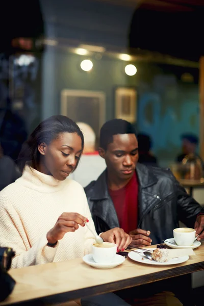 Two young friends talk and drink coffee in cafe, good friends enjoying coffee in beautiful place, cold winter days in beautiful coffee shop, friends at breakfast having coffee and enjoying themselves — Stock Photo, Image