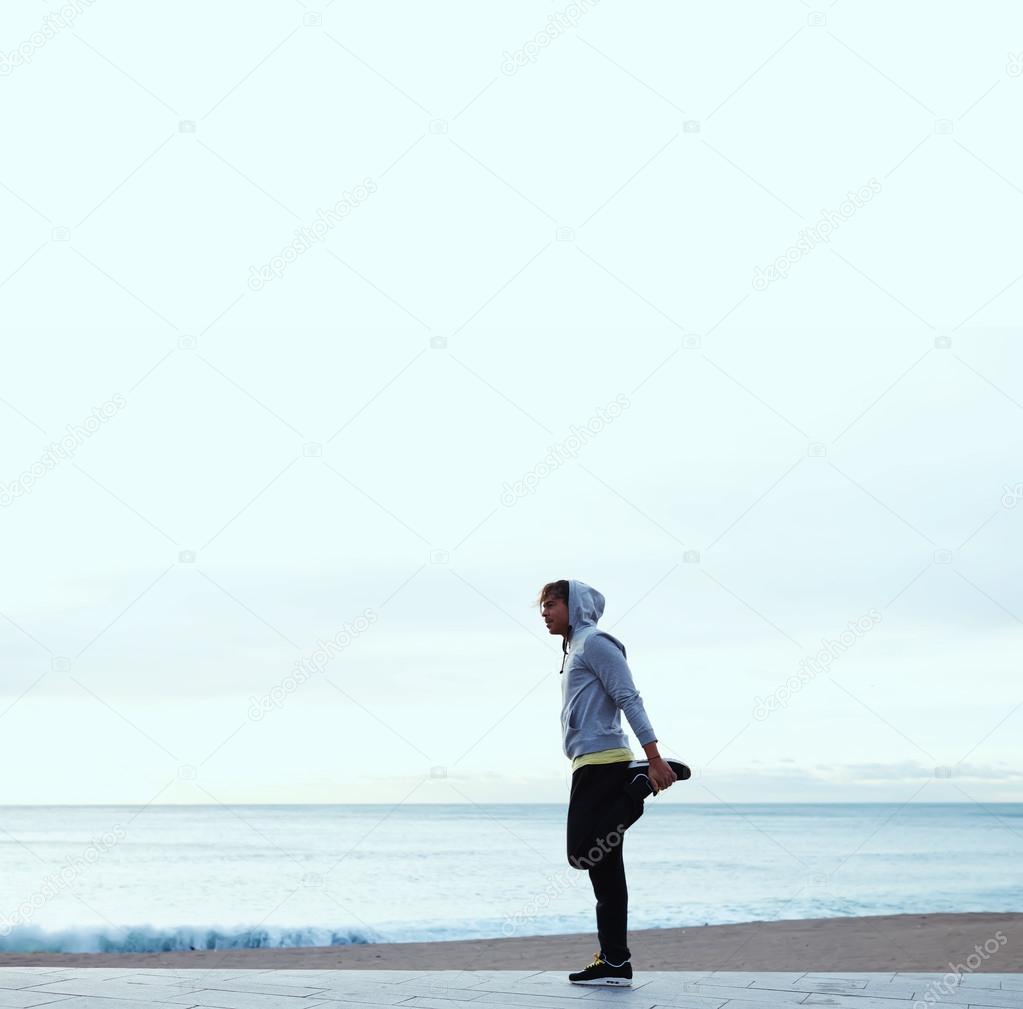 Young  man exercising on beach