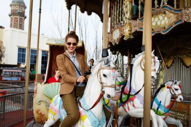 woman riding on a merry go round