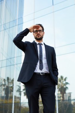 businessman in glasses looking off