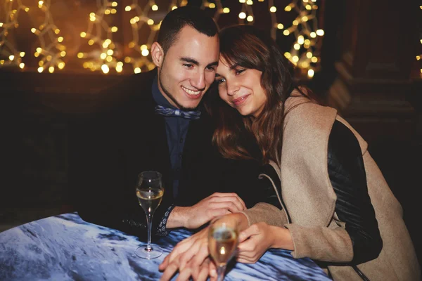 Young couple hugging while dinner — Stock Photo, Image