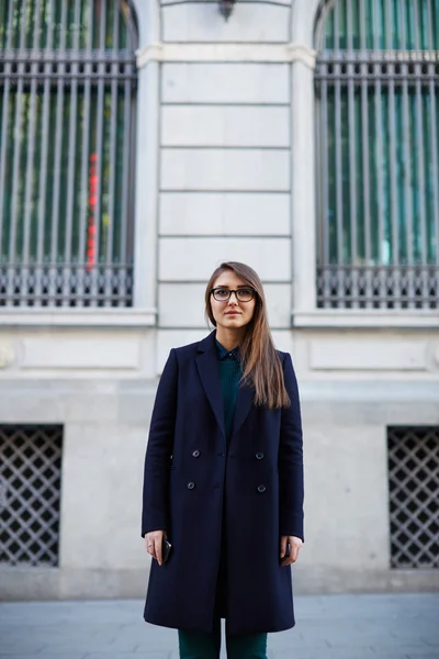 Gorgeous female in stylish coat standing in the city — 图库照片