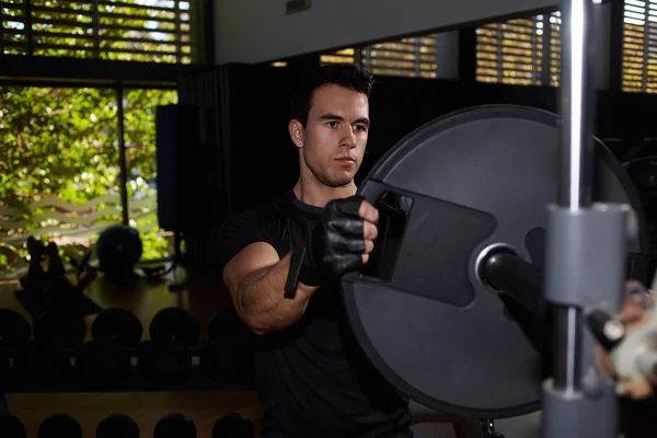 Man preparing barbell for working out — Stock Photo, Image