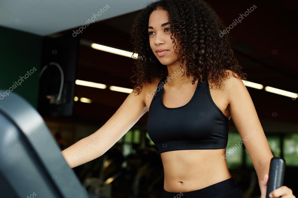 Premium Photo  Curly-haired sportswoman performing an upper back exercise