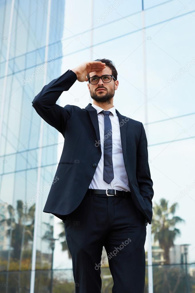 businessman in glasses looking off