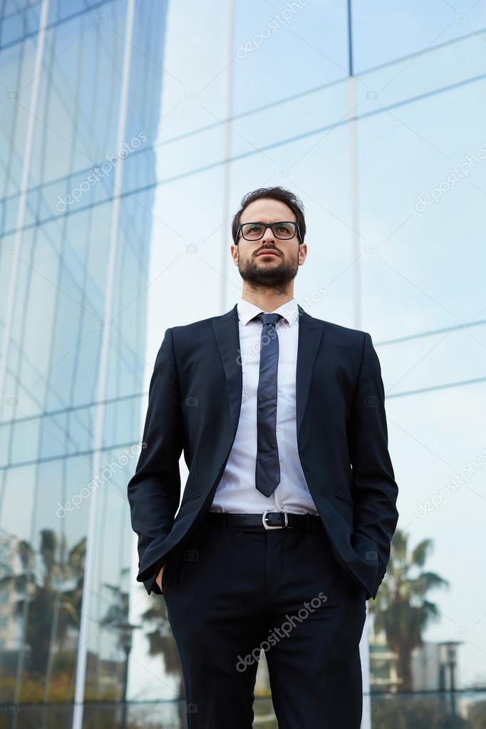 businessman standing with his hands in the pockets