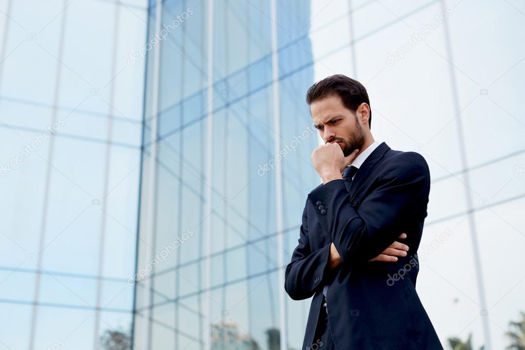 business man standing with arm crossed