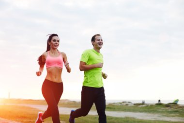 young smiling couple running