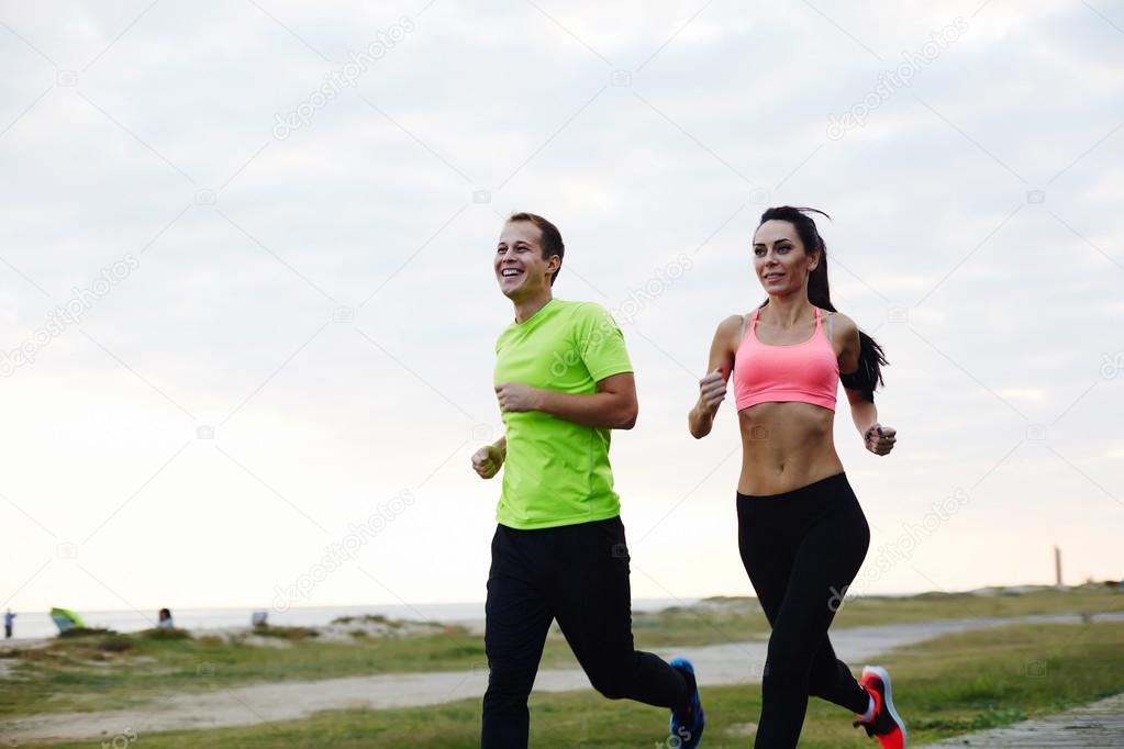 young smiling couple running