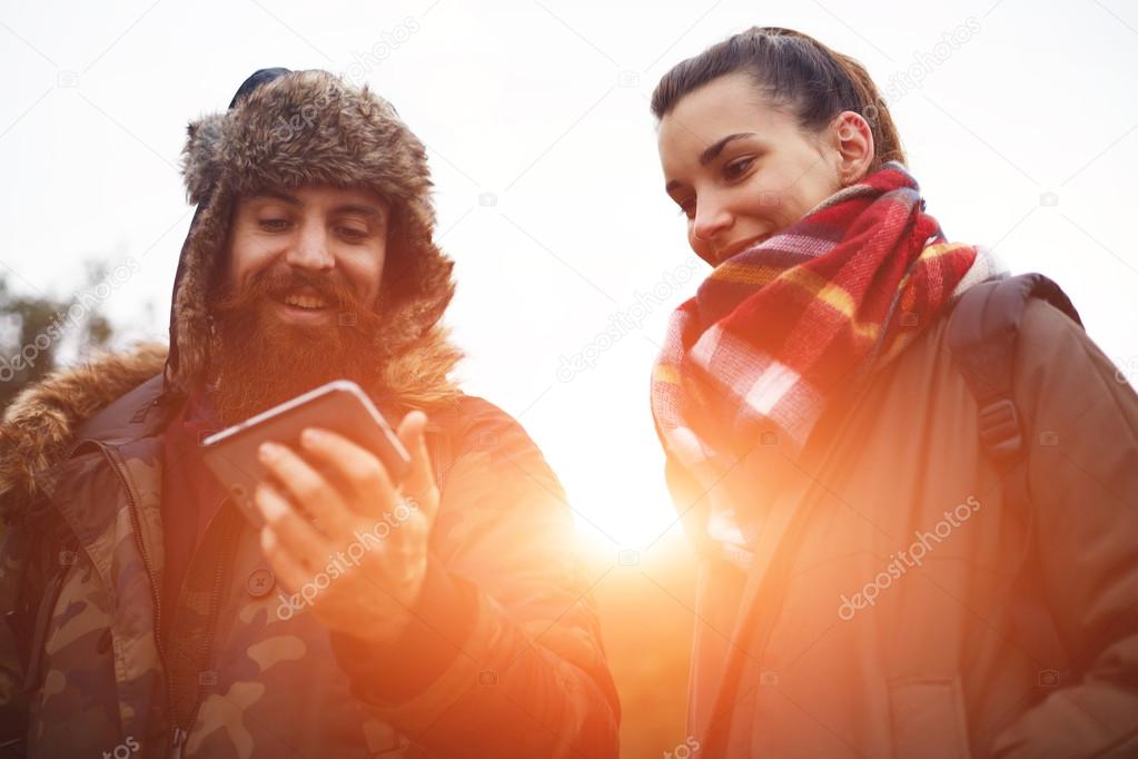 Young couple of backpackers enjoying a day out in nature together