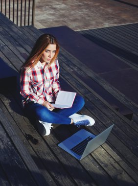 Öğrenci kitap ve dizüstü bilgisayar ile
