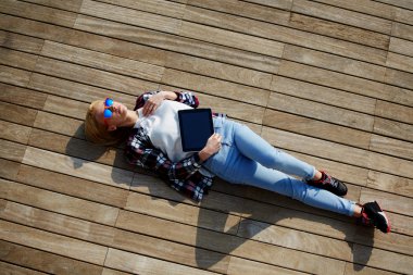 Woman lying on the wooden jetty clipart