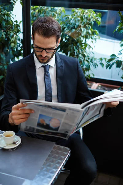 Uomo d'affari seduto in una caffetteria — Foto Stock