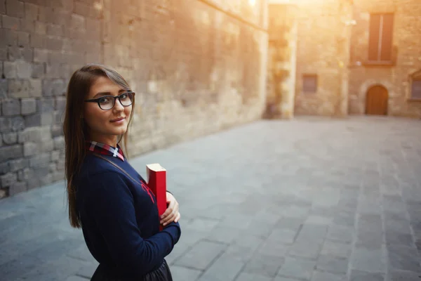 Student standing outside holding her book — Stock Photo, Image