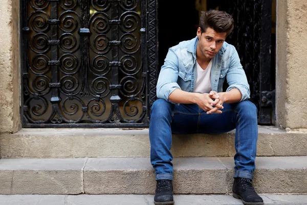 Man sitting on a staircase — Stock Photo, Image