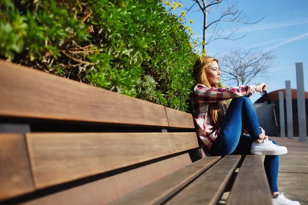 Mujer en el banco disfrutando de la naturaleza — Foto de Stock