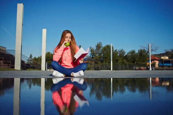 Teenager reading absorbing book — Stock Photo, Image