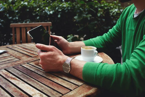 Frilanser sitter på terrassen med en kopp kaffe. – stockfoto